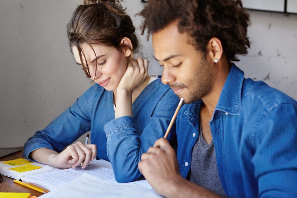 students doing work at a desk